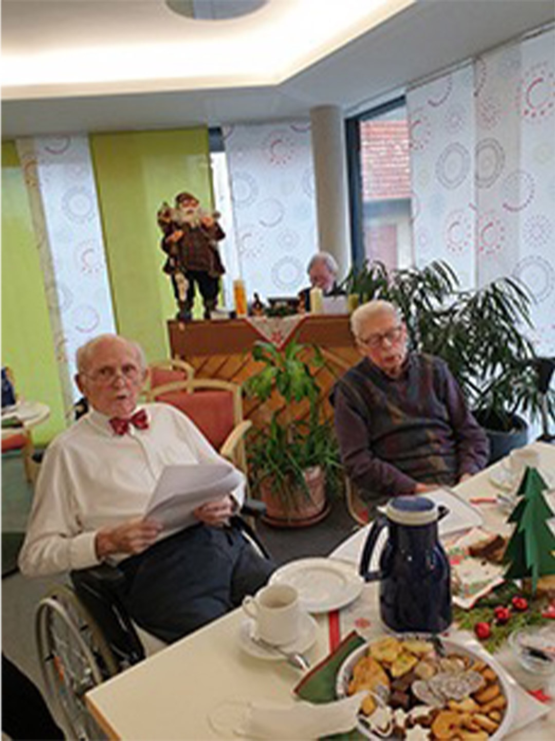 Evdiak Bild von Senioren an einem Tisch mit Tee und Gesangsblättern